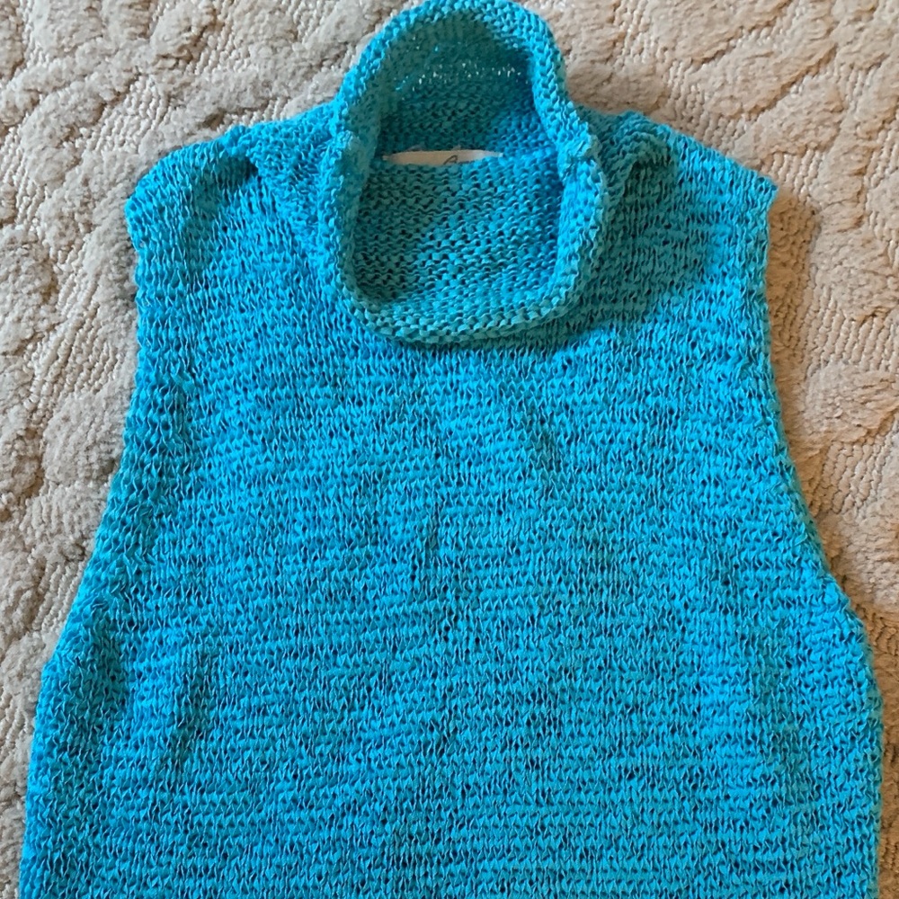 Crocheted sleeveless turtle neck top.